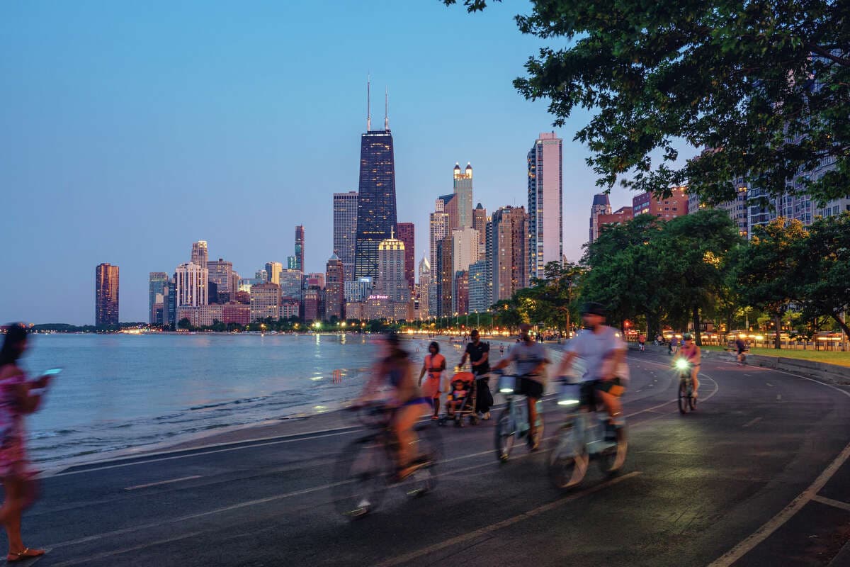 Image of people riding bicycles along Lake Michigan.